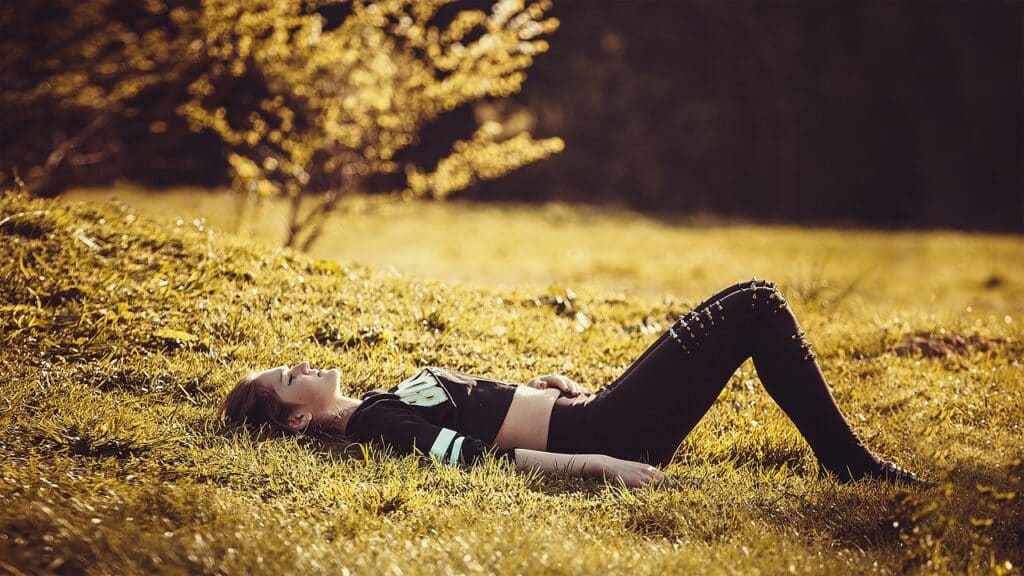 girl lying on the grass relaxing- relaxation